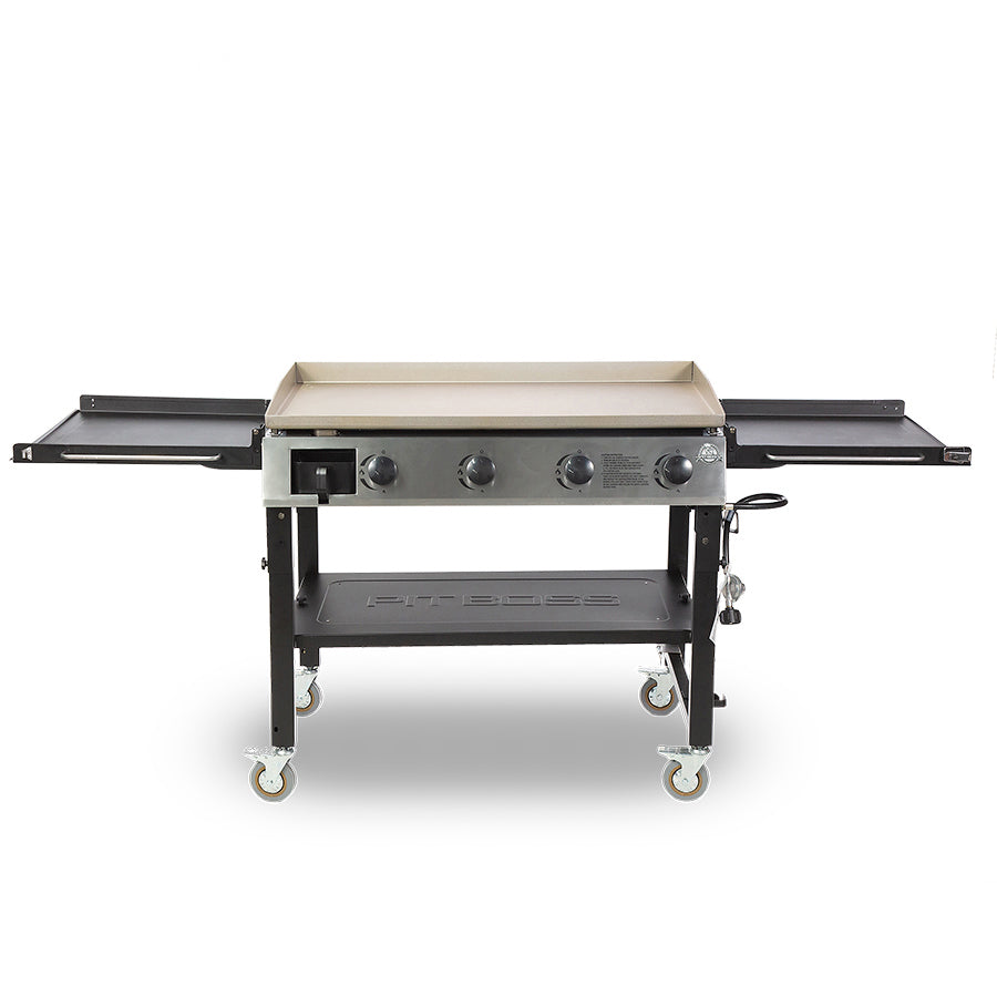 Pit Boss Deluxe 4-Burner Griddle. Both side tables open. Black grill with beige and silver accents. Front view.