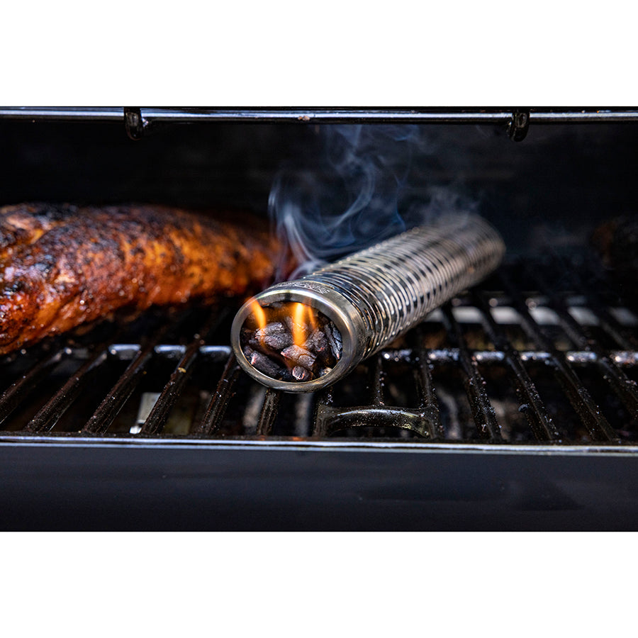 Close up of wood pellets in smoking tube in grill.