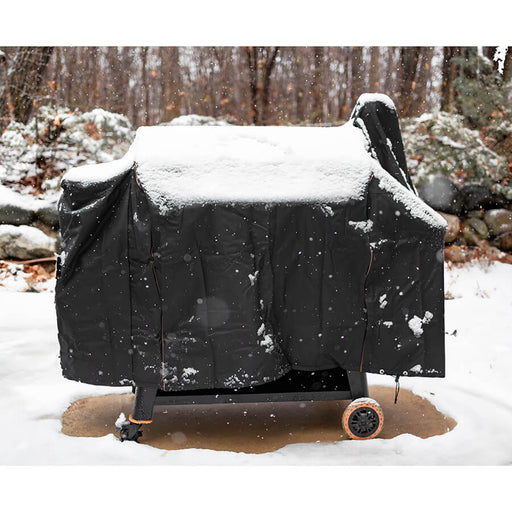 black and orange bbq grill cover outside in snow