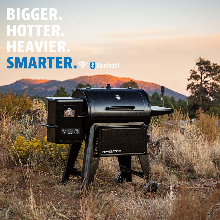 The Pit Boss navigator 850 wood pellet grill shown in a desert mountain setting. Black grill with white logo.