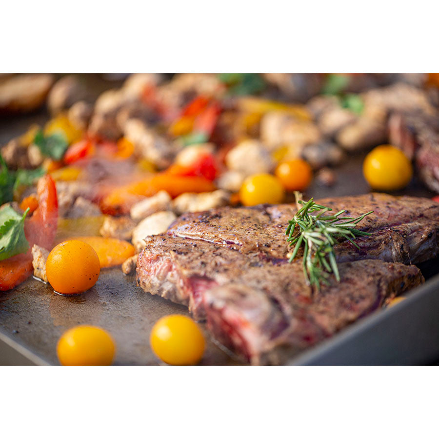 Close up of steak and veggies cooking.