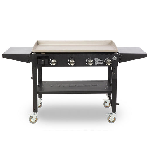 Pit Boss Standard 4-Burner Griddle. Side tables out. Black griddle with beige and silver accents. Pit Boss engraved on the bottom shelf.