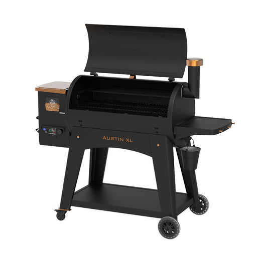 Pit Boss Austin XL 1000 Wood Pellet Grill in black with orange and bronze accents. Pellet hopper and grease bucket displayed. Open hood. Side view.