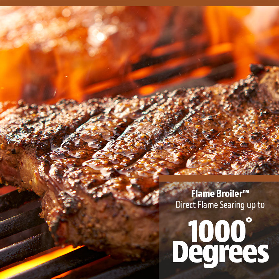 Up close of steak being seared in open flame on grill rack.