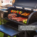 Meats and veggies being grilled on both grilling racks. Side view. In a backyard setting.