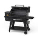 Black grill displayed with side profile. Open grilling hood. Pellet hooper and side table displayed