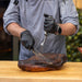 Meat being cut and held down by Pit Boss knives.