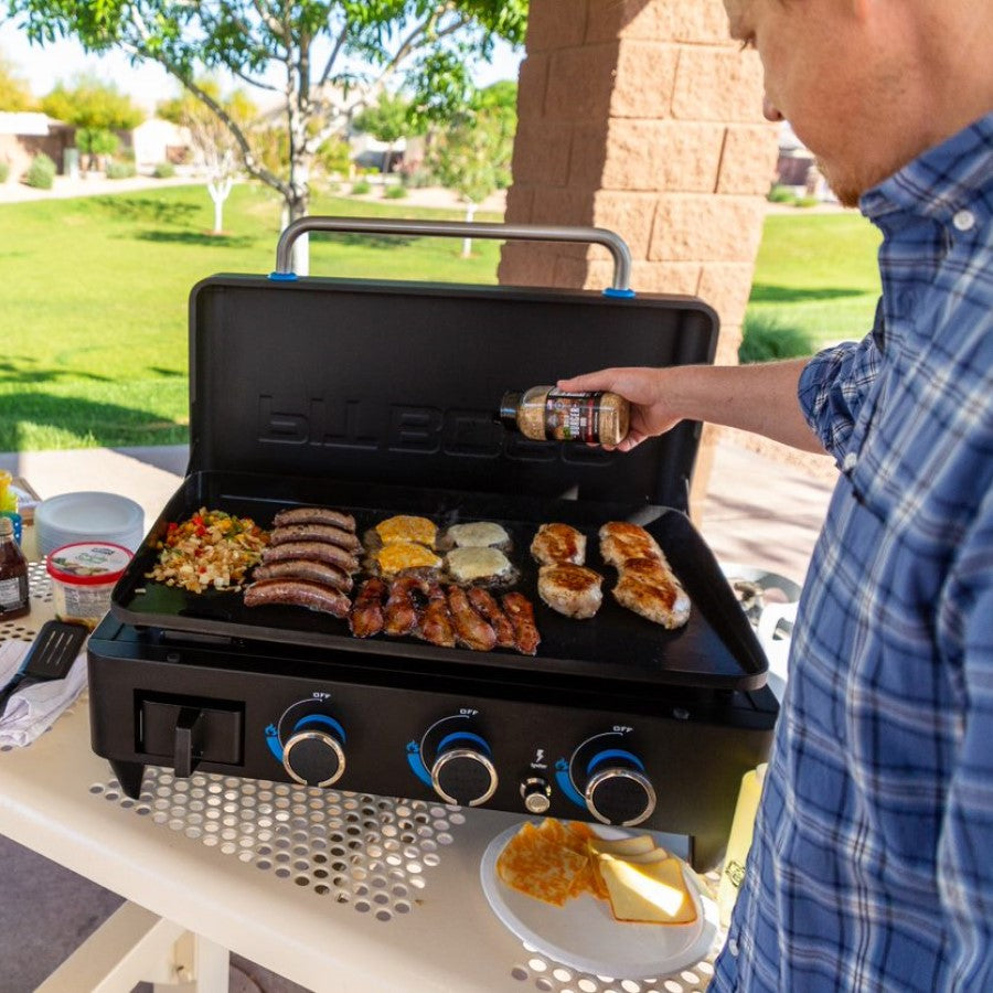 lifestyle_6, Black griddle with bright blue and silver accents with large Pit Boss logo in blue on front.