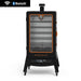 Sportsman 7-Series Wood Pellet Vertical Smoker. Black with orange accents. Five grilling racks inside. Front view.