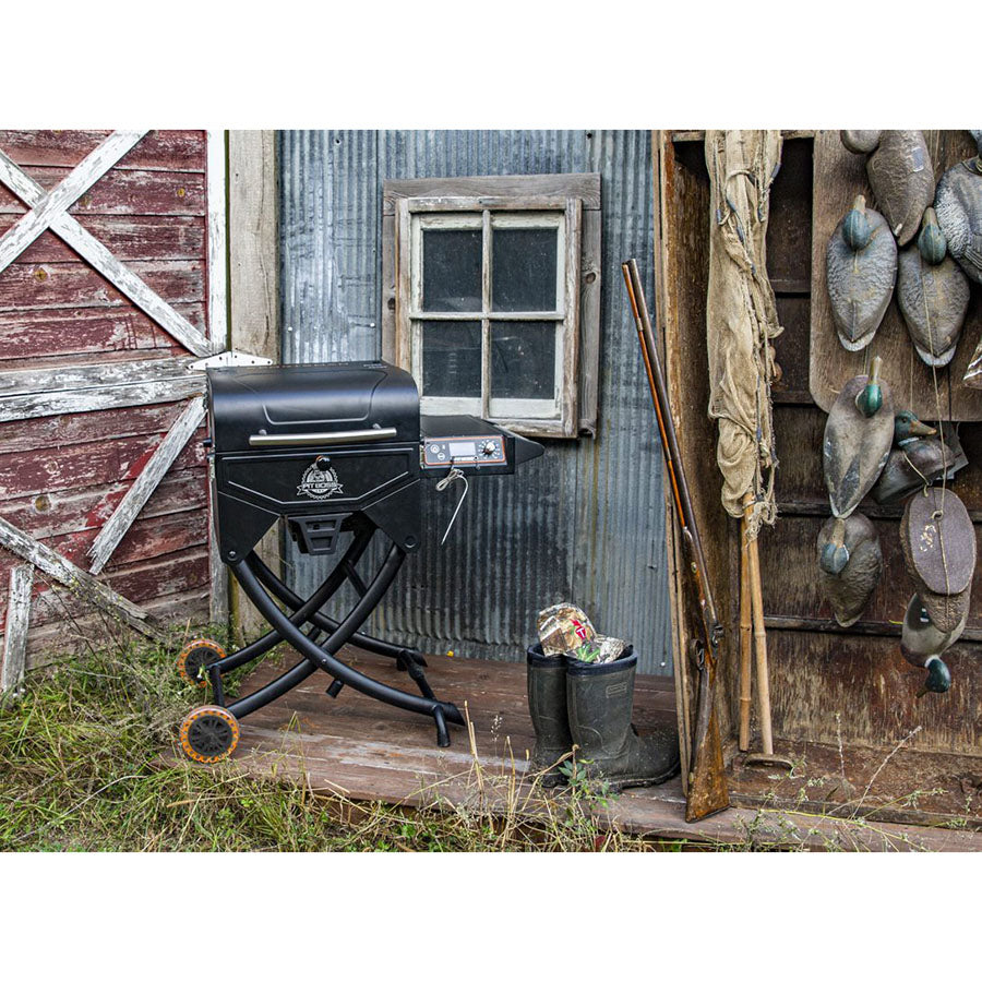 grill sitting next to rustic looking hunting shed