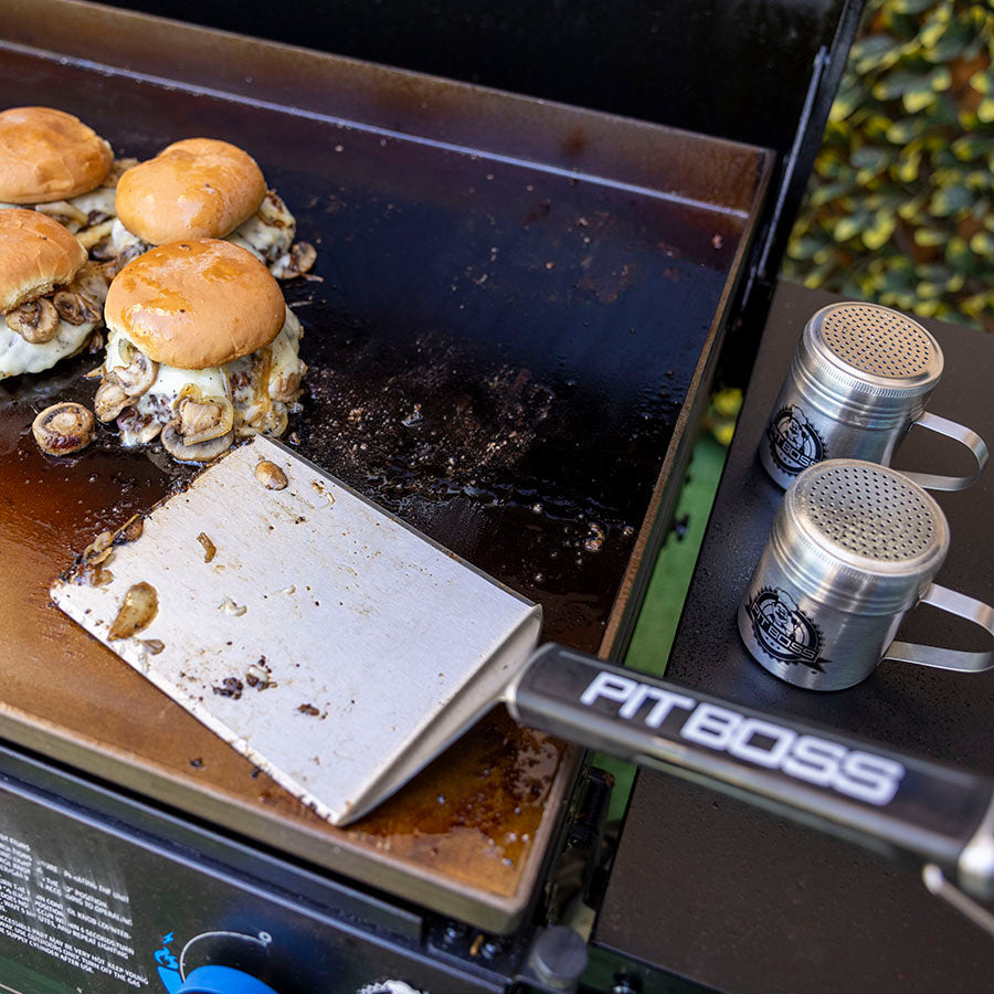 lose up of the big head spatula on a griddle.