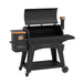 Pit Boss Austin XL 1000 Wood Pellet Grill in black with orange and bronze accents. Pellet hopper and grease bucket displayed. Open hood. Side view