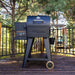 grill standing on porch with woodsy background