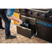 Close up of the drawers located on the left side of the griddle. Man storing trash bags on the bottom.