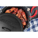 lifestyle_3, Sesame wings in dutch oven with lid partially off sitting on wood table with chiles and garlic on the side