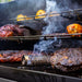 Smoke tube in main grilling rack with meats and veggies on all three grilling racks.