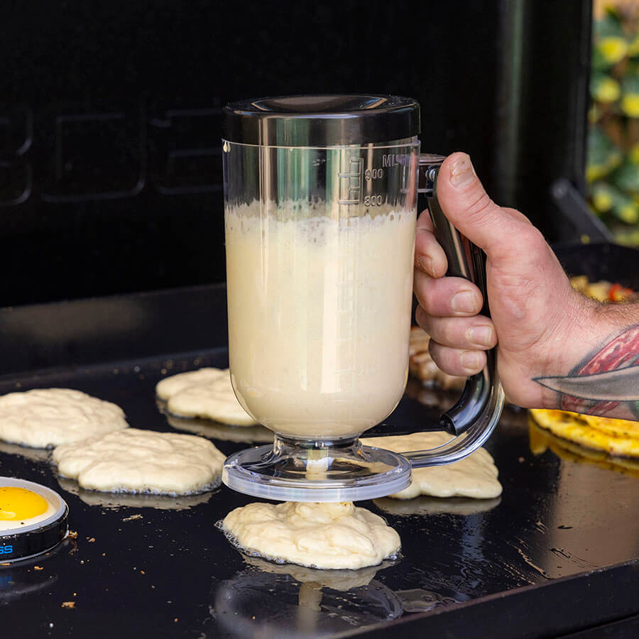 Close action shot of pancakes being made with the Pit Boss   pancake dispenser.