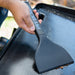 Close up of the griddle scrapper cleaning up the griddle.